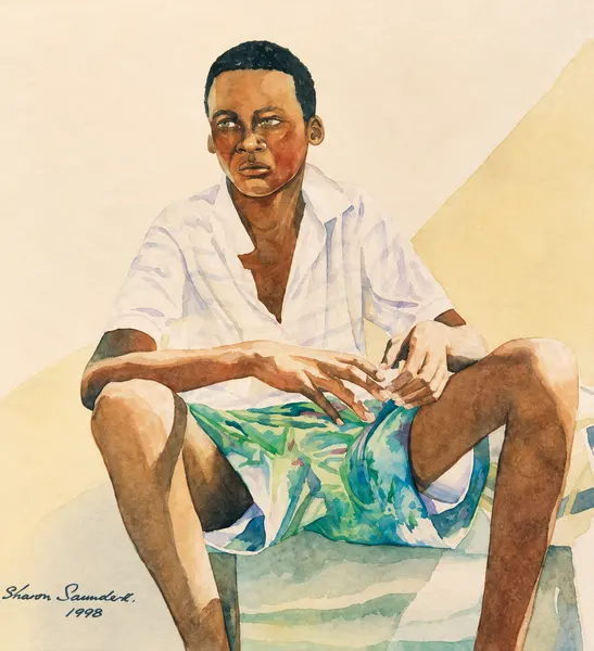 Seated man in patterned shorts.